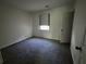 A cozy bedroom featuring neutral walls, carpeted floor, and a window that provides natural light at 3832 Natalie Way, Ellenwood, GA 30294