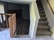 View of the entryway and stairs, leading to a living room with a fireplace, creating a warm and inviting atmosphere at 3832 Natalie Way, Ellenwood, GA 30294
