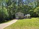 Charming two-story home with a garage on a sprawling green lawn surrounded by lush trees at 3832 Natalie Way, Ellenwood, GA 30294