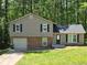 Charming home with a well-maintained lawn, neutral-colored siding, and a brick facade on the lower level at 3832 Natalie Way, Ellenwood, GA 30294