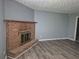 Living room showcasing a brick fireplace and light gray walls at 3832 Natalie Way, Ellenwood, GA 30294