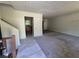 Open living room with a tile entryway, carpeted living area and a view of the kitchen at 3832 Natalie Way, Ellenwood, GA 30294