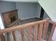 Cozy living room features brick fireplace, gray walls, and wood-look floors, viewed from the staircase at 3832 Natalie Way, Ellenwood, GA 30294