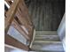 View of the staircase with newly renovated tile flooring and wood banisters leading up to the second story at 3832 Natalie Way, Ellenwood, GA 30294
