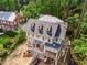 Aerial view of a house under construction, situated on a lot surrounded by lush greenery at 1176 Lullwater Ne Rd, Atlanta, GA 30307