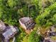 Aerial view of a house in a green, wooded neighborhood; the home is under construction at 1176 Lullwater Ne Rd, Atlanta, GA 30307