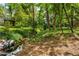 Lush backyard with a gently flowing stream, creating a serene and picturesque natural setting at 1176 Lullwater Ne Rd, Atlanta, GA 30307