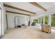 Open-concept living area with timber beams, windows and archways, full of natural light at 1176 Lullwater Ne Rd, Atlanta, GA 30307