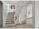 White staircase featuring wood railing and wainscoting, illuminated by natural light from nearby windows at 1176 Lullwater Ne Rd, Atlanta, GA 30307