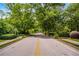 Street view with mature trees and shrubbery that contribute to a peaceful environment at 1176 Lullwater Ne Rd, Atlanta, GA 30307