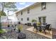 Home's backyard with patio seating, gravel, greenhouse, and exterior with white siding at 268 Cottonwood Creek Cir, Canton, GA 30114