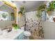 Well-lit bathroom featuring floral shower curtain, ample plants, and a clean aesthetic at 268 Cottonwood Creek Cir, Canton, GA 30114
