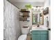 Bathroom featuring teal vanity, shelves, a large mirror, and a shower with curtain at 268 Cottonwood Creek Cir, Canton, GA 30114