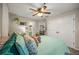 Bright bedroom with a ceiling fan, closet, decorative shelves and a view through to the bathroom at 268 Cottonwood Creek Cir, Canton, GA 30114