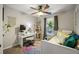 Bedroom features a ceiling fan, colorful rug, desk space and lots of natural light at 268 Cottonwood Creek Cir, Canton, GA 30114
