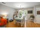 Charming dining area with hardwood floors, a stylish table set, and a door leading to the backyard at 268 Cottonwood Creek Cir, Canton, GA 30114