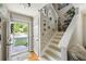 Inviting entryway with bright blue door, wood floors, and charming decor leading to an inviting staircase at 268 Cottonwood Creek Cir, Canton, GA 30114