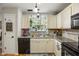 Efficient kitchen with granite countertops, modern appliances, and a window overlooking the backyard garden at 268 Cottonwood Creek Cir, Canton, GA 30114