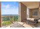 Large balcony with lounge seating, offering expansive views of the lush landscape and city skyline at 2881 Peachtree Ne Rd # 2304, Atlanta, GA 30305
