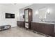 Bathroom featuring double sinks with dark wood cabinets, TV, and modern mirrors at 2881 Peachtree Ne Rd # 2304, Atlanta, GA 30305