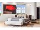 Close up of bed with bench, large windows, and accent wall art at 2881 Peachtree Ne Rd # 2304, Atlanta, GA 30305
