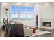 Cozy living room featuring a fireplace, stylish decor, and large windows offering ample natural light at 2881 Peachtree Ne Rd # 2304, Atlanta, GA 30305