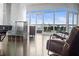 Bright living room with floor-to-ceiling windows offering panoramic city views and access to the balcony at 2881 Peachtree Ne Rd # 2304, Atlanta, GA 30305