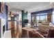 Open-concept living room, kitchen, and dining area featuring hardwood floors, fireplace, large windows, and modern decor at 2881 Peachtree Ne Rd # 2304, Atlanta, GA 30305