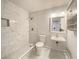 Modern bathroom featuring marble tiled shower and sink with a mirrored vanity and storage cabinet at 2981 Judylyn Dr, Decatur, GA 30033