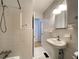 This bathroom features classic tile work, a walk-in shower, and a pedestal sink with new lighting at 2981 Judylyn Dr, Decatur, GA 30033
