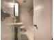 A well-lit bathroom with a pedestal sink, tiled walls, and a bathtub and shower at 2981 Judylyn Dr, Decatur, GA 30033