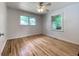 Well-lit bedroom features hardwood floors, neutral walls, and a ceiling fan at 2981 Judylyn Dr, Decatur, GA 30033