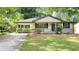 A lovely single-story home with a quaint front porch, complemented by lush greenery and a well-kept lawn at 2981 Judylyn Dr, Decatur, GA 30033