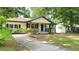 Inviting single-story home featuring a cozy front porch and a neatly manicured front yard at 2981 Judylyn Dr, Decatur, GA 30033