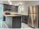 Renovated kitchen featuring gray cabinets, butcher block countertops, and stainless steel refrigerator at 2981 Judylyn Dr, Decatur, GA 30033