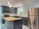 This newly remodeled kitchen features stainless steel appliances and a butcher block island at 2981 Judylyn Dr, Decatur, GA 30033