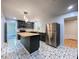 A modern kitchen with butcher block countertops, stainless appliances, and black, gray, and white tile flooring at 2981 Judylyn Dr, Decatur, GA 30033