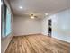 Bright living room featuring gleaming hardwood floors, a ceiling fan, and fresh paint at 2981 Judylyn Dr, Decatur, GA 30033