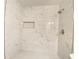 Beautiful walk-in shower featuring marble tiled walls with a built-in niche and tiled shower floor at 2981 Judylyn Dr, Decatur, GA 30033