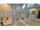 Bright bathroom with a soaking tub, walk-in shower, and dual vanity at 303 Sedgewick Trl, Lawrenceville, GA 30044