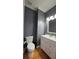 The bathroom features hardwood floors, modern vanity, and gray walls at 303 Sedgewick Trl, Lawrenceville, GA 30044