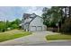 Home exterior with three car garage, basketball hoop, and spacious driveway at 303 Sedgewick Trl, Lawrenceville, GA 30044