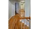 Second floor hallway with hardwood floors overlooking the staircase at 303 Sedgewick Trl, Lawrenceville, GA 30044
