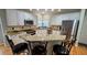 Open concept kitchen with white cabinets, granite countertops, and stainless steel appliances at 303 Sedgewick Trl, Lawrenceville, GA 30044