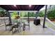 This covered patio has an outdoor dining table with seating for four at 303 Sedgewick Trl, Lawrenceville, GA 30044