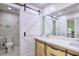 Modern bathroom featuring a sliding barn door, marble tile, and a stylish wood vanity at 3285 Long Iron Pl, Lawrenceville, GA 30044