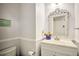 Charming powder room featuring a modern vanity, decorated mirror, and light gray walls at 3285 Long Iron Pl, Lawrenceville, GA 30044