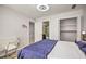 Cozy bedroom featuring wood floors, modern lighting, and access to the bathroom and closet at 3285 Long Iron Pl, Lawrenceville, GA 30044