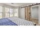 Inviting bedroom with a sliding barn door and a bright window offering a pleasant view at 3285 Long Iron Pl, Lawrenceville, GA 30044