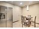 A stainless-steel refrigerator stands near a dining table in this home's dining area at 3285 Long Iron Pl, Lawrenceville, GA 30044